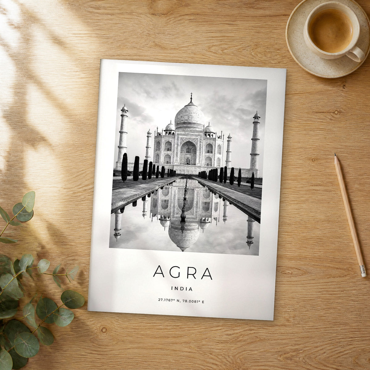 Unframed Agra black and white travel poster on a wooden table