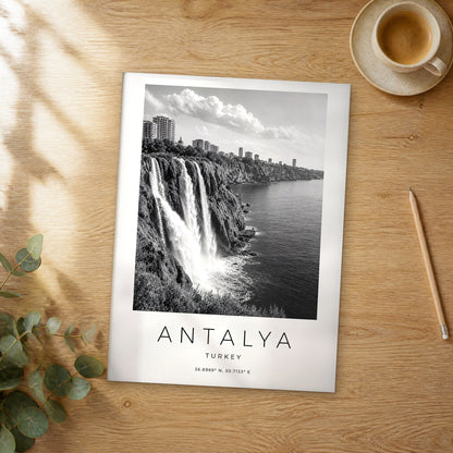 Unframed Antalya black and white travel poster on a wooden table