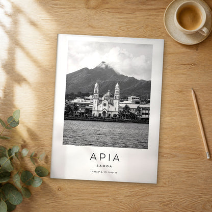 Unframed Apia black and white travel poster on a wooden table