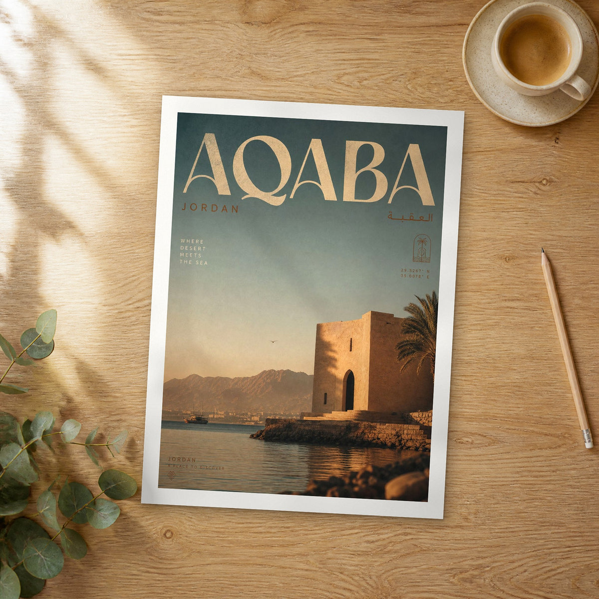 Unframed Aqaba bold typography travel poster on a wooden table
