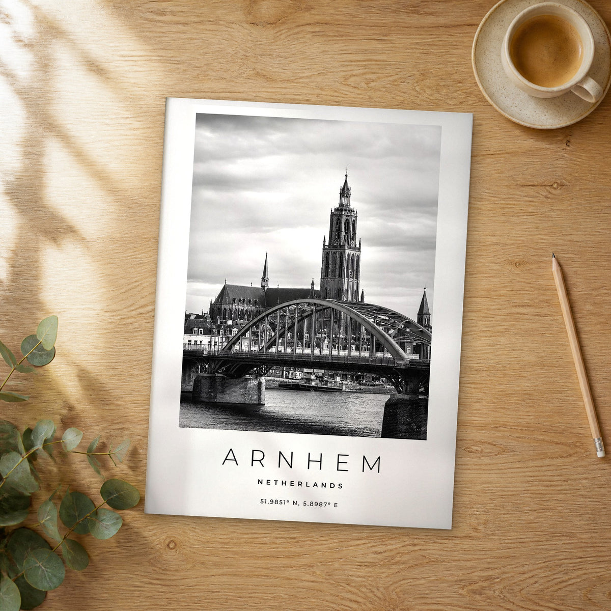 Unframed Arnhem black and white travel poster on a wooden table
