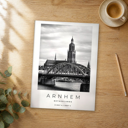Unframed Arnhem black and white travel poster on a wooden table