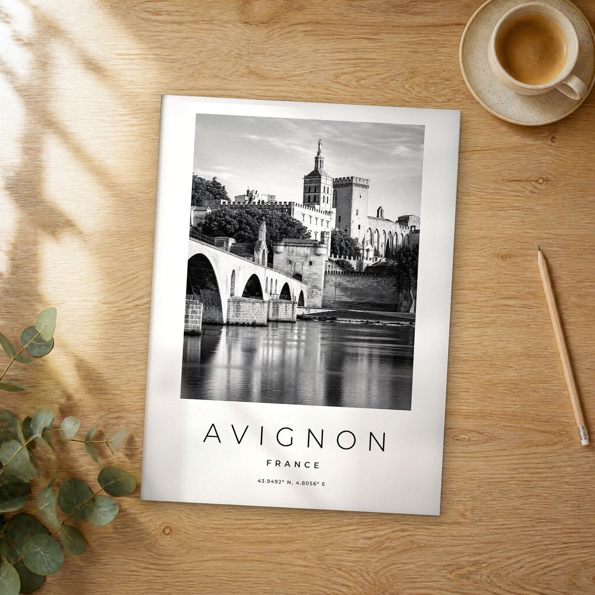 Unframed Avignon black and white travel poster on a wooden table
