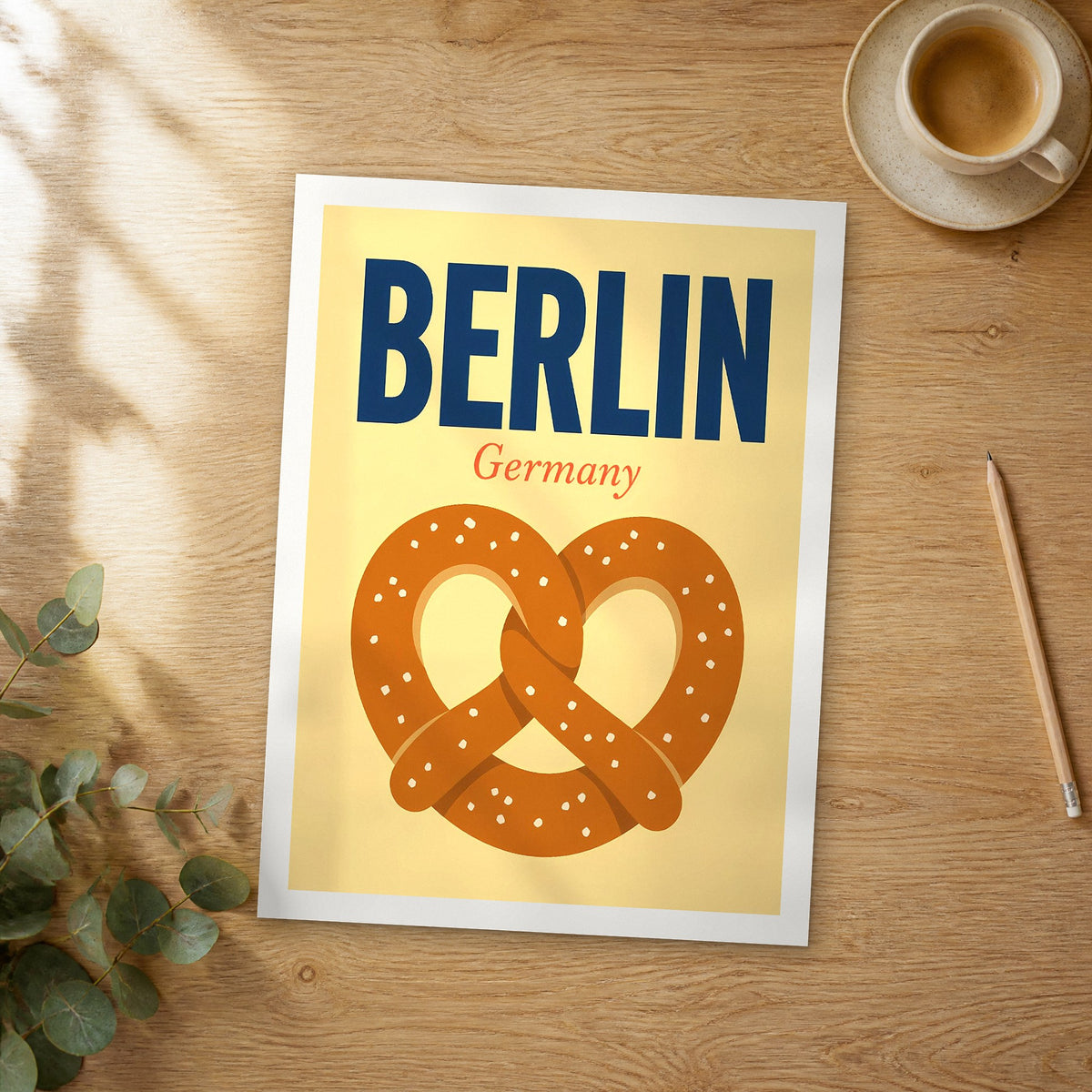 Unframed Berlin pop art travel poster on a wooden table