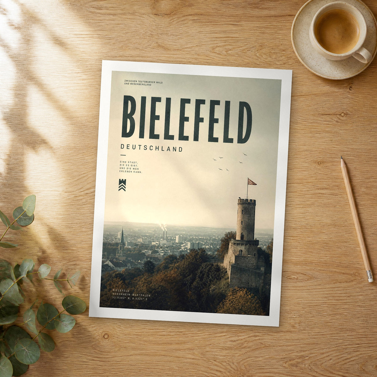 Unframed Bielefeld bold typography travel poster on a wooden table