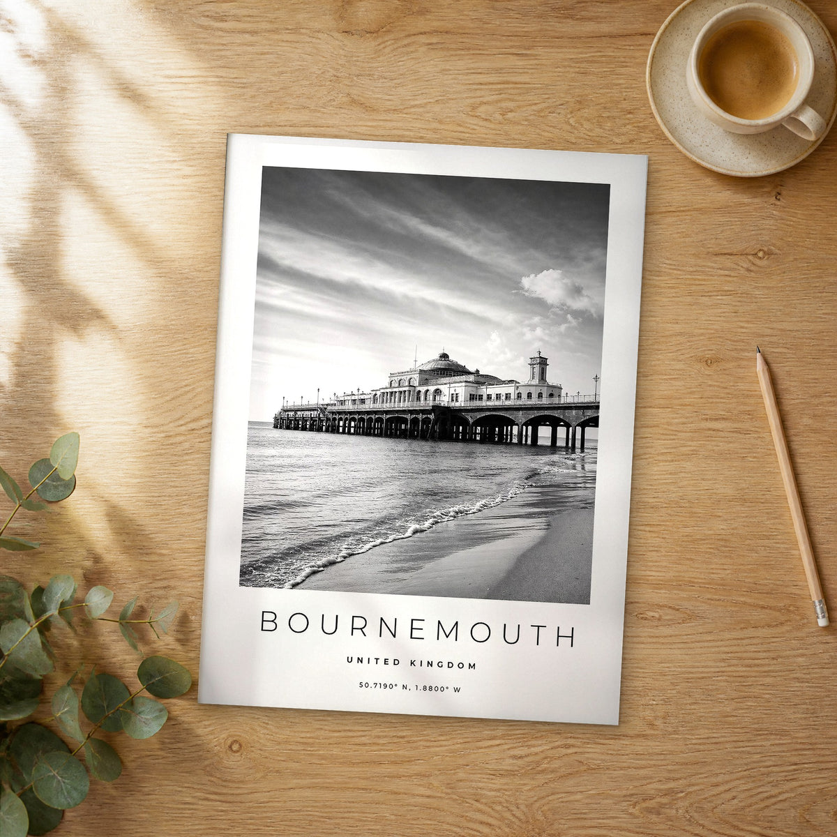Unframed Bournemouth black and white travel poster on a wooden table