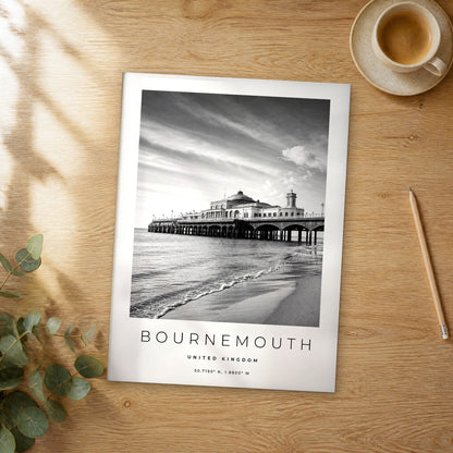 Unframed Bournemouth black and white travel poster on a wooden table