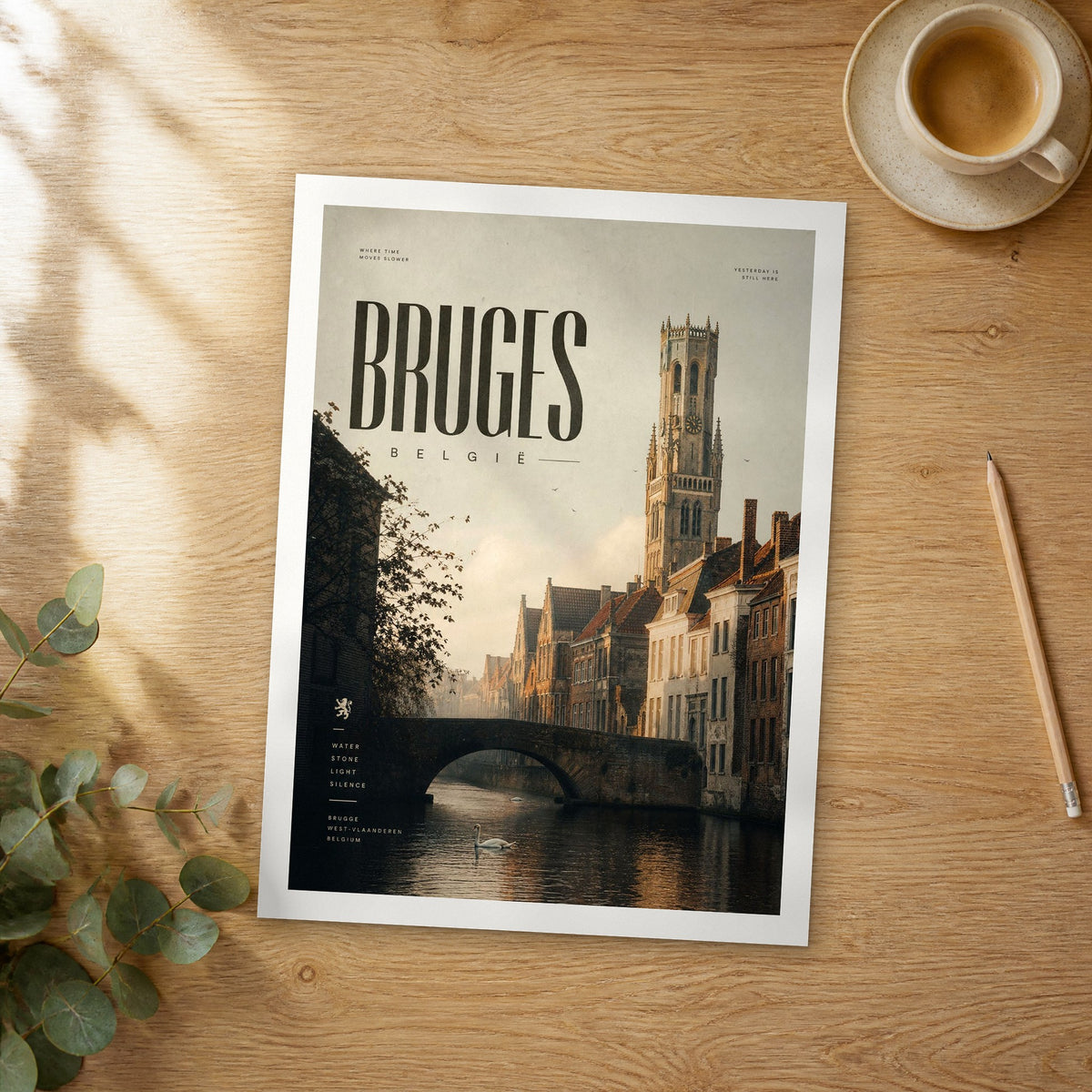 Unframed Bruges bold typography travel poster on a wooden table