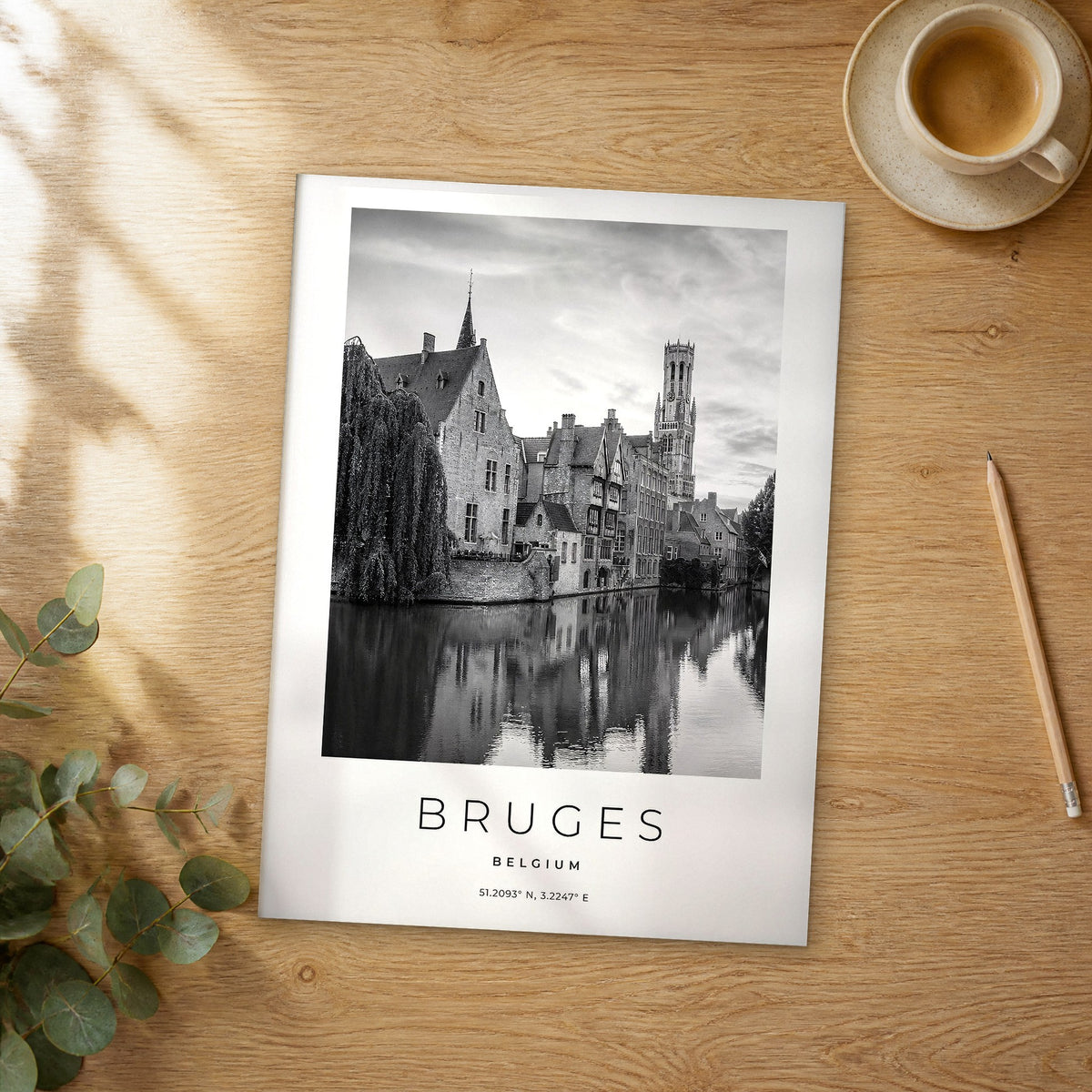 Unframed Bruges Rozenhoedkaai black and white travel poster on a wooden table