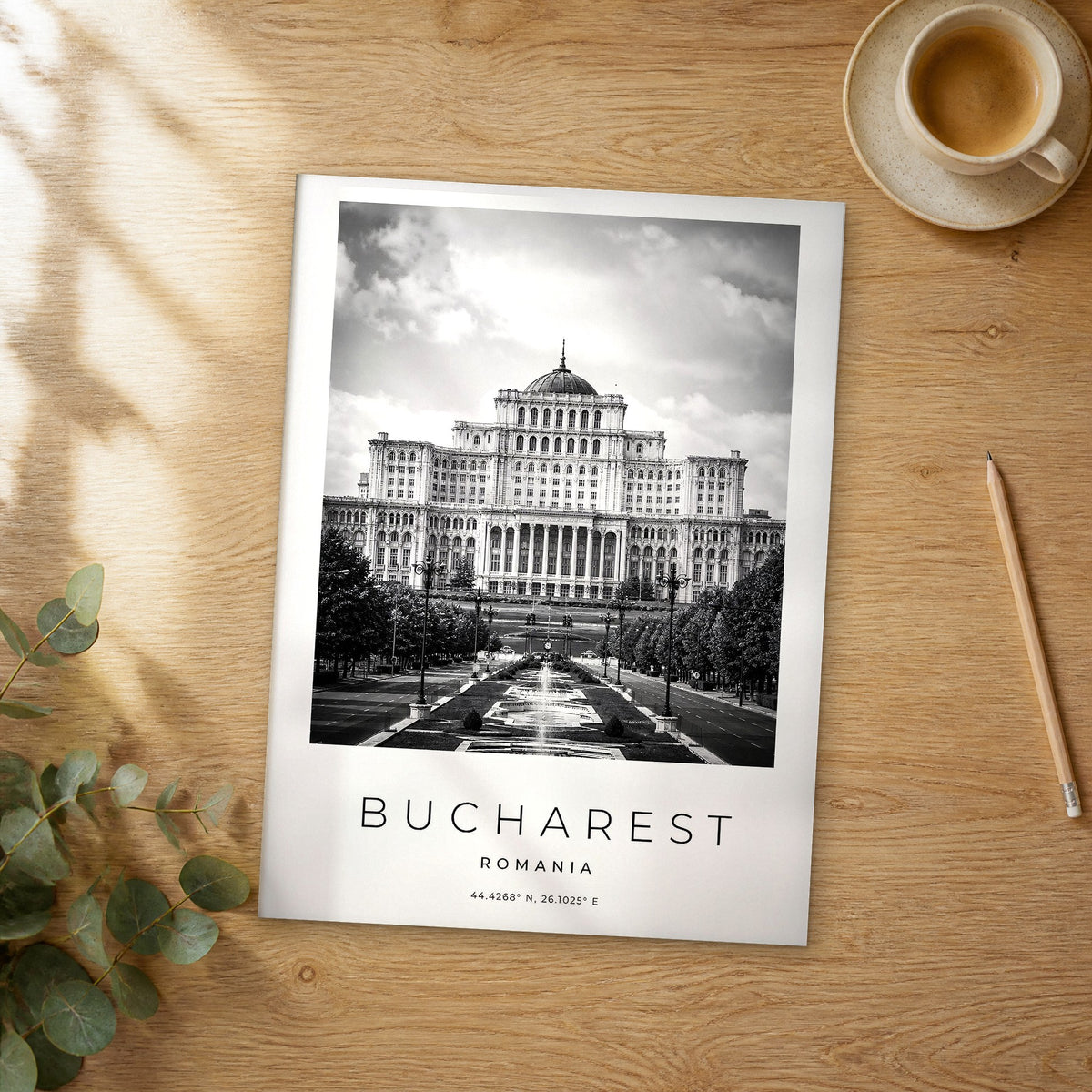 Unframed Bucharest black and white travel poster on a wooden table