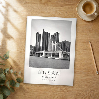 Unframed Busan black and white travel poster on a wooden table