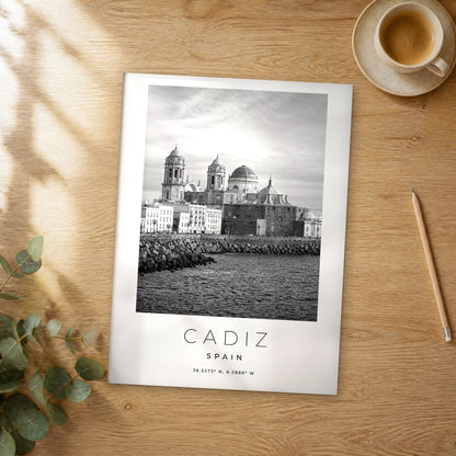 Unframed Cadiz black and white travel poster on a wooden table