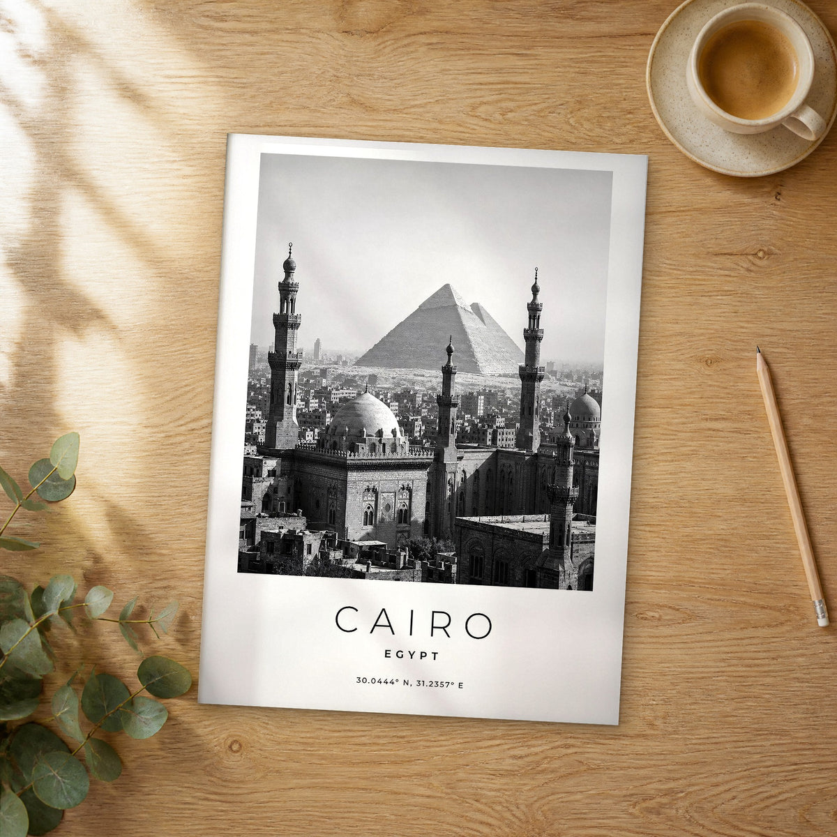 Unframed Cairo black and white travel poster on a wooden table
