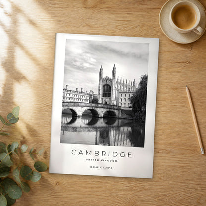Unframed Cambridge black and white travel poster on a wooden table