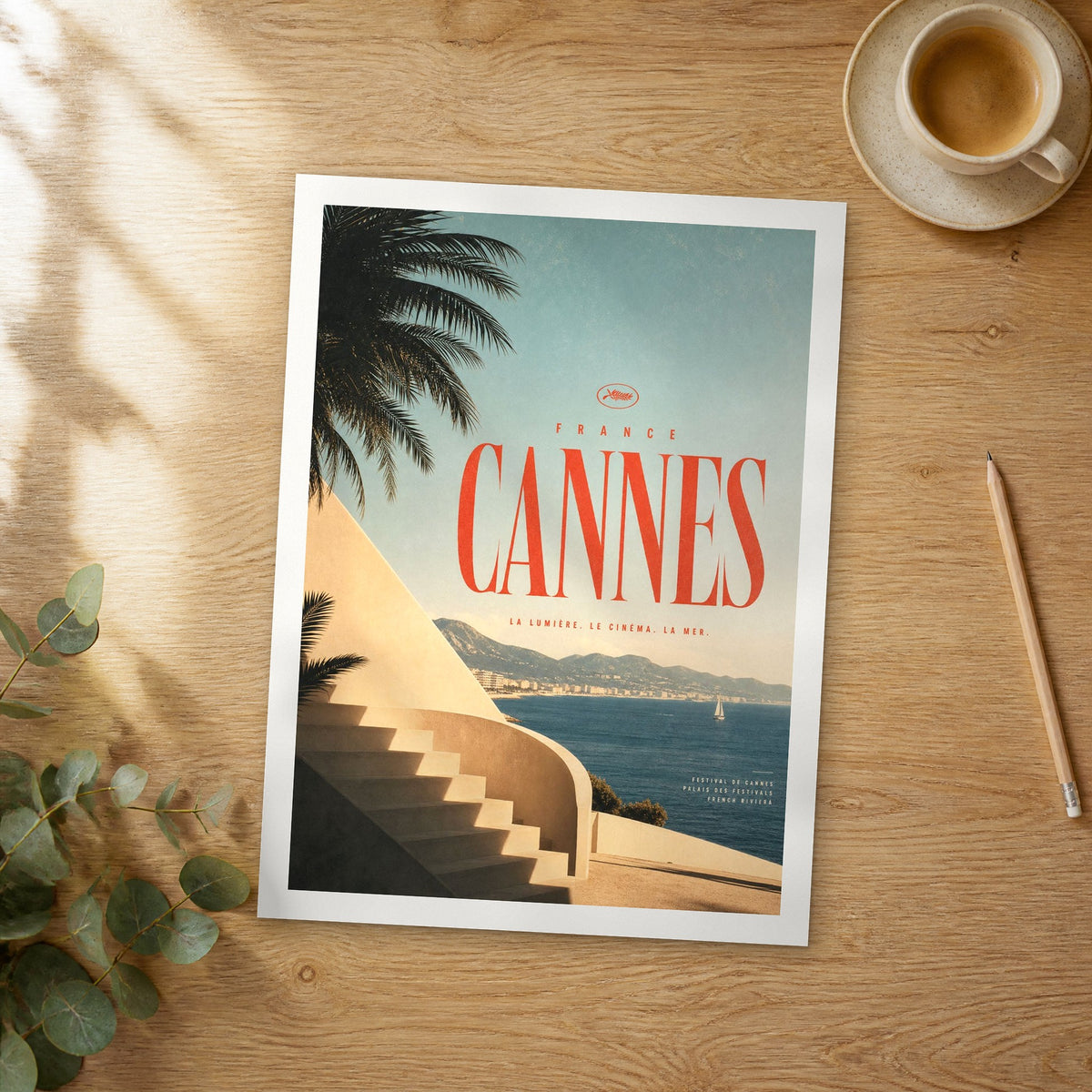 Unframed Cannes bold typography travel poster on a wooden table
