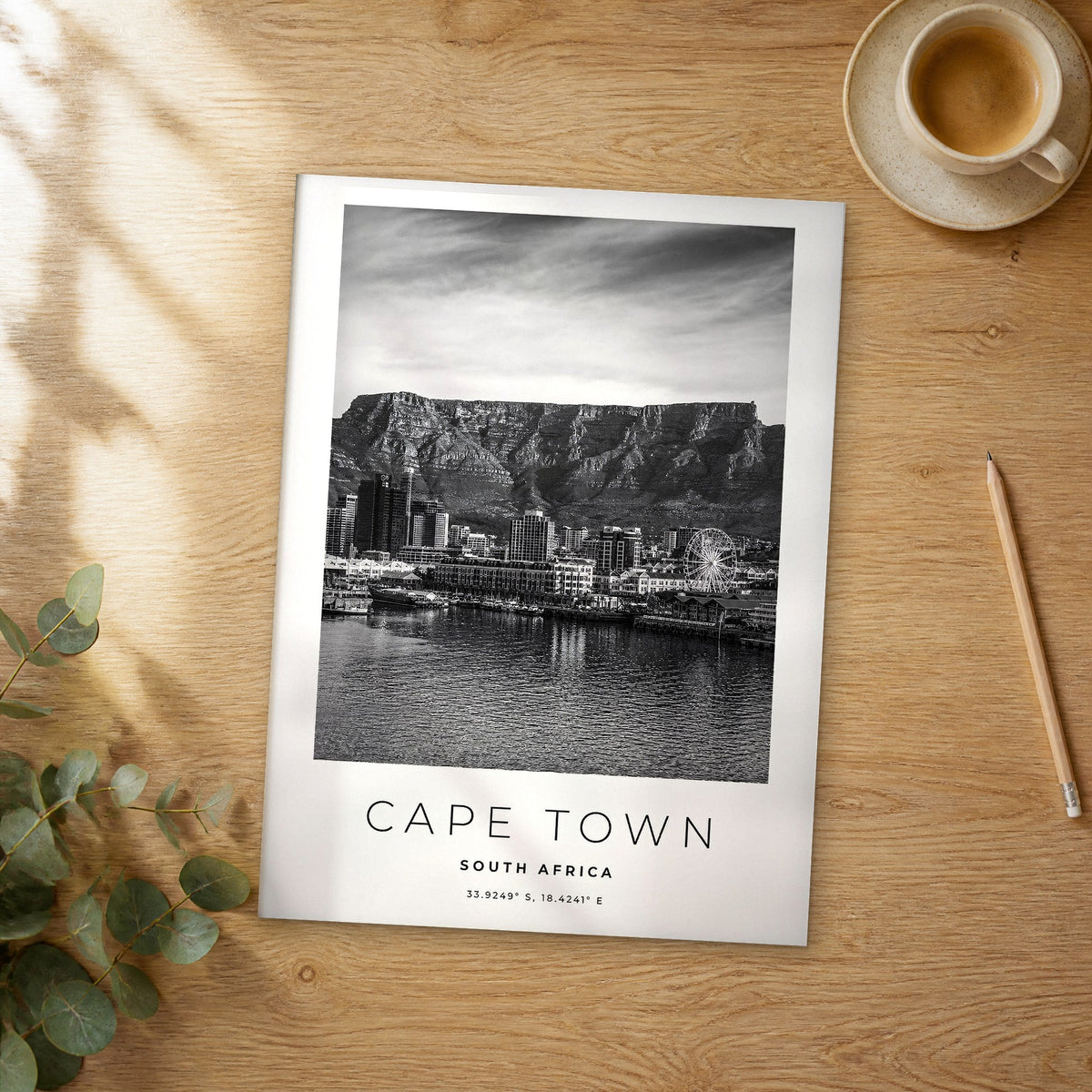 Unframed Cape Town black and white travel poster on a wooden table