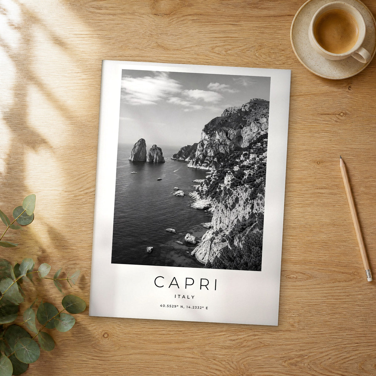 Unframed Capri black and white travel poster on a wooden table
