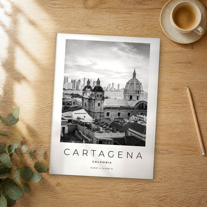 Unframed Cartagena black and white travel poster on a wooden table