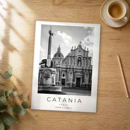 Unframed Catania black and white travel poster on a wooden table