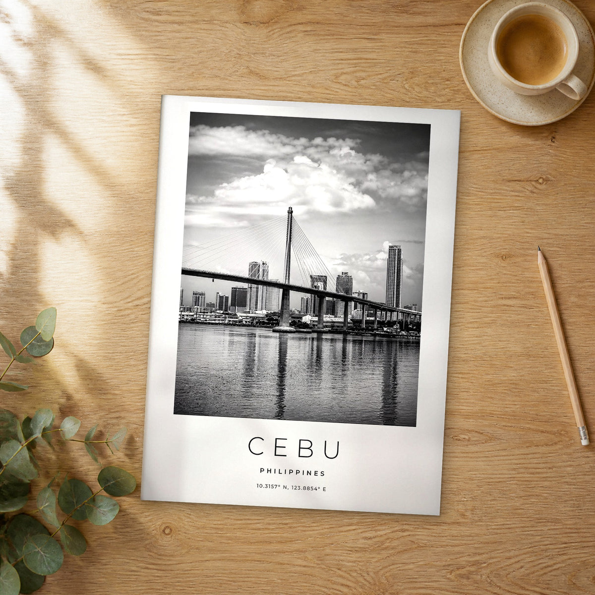 Unframed Cebu black and white travel poster on a wooden table