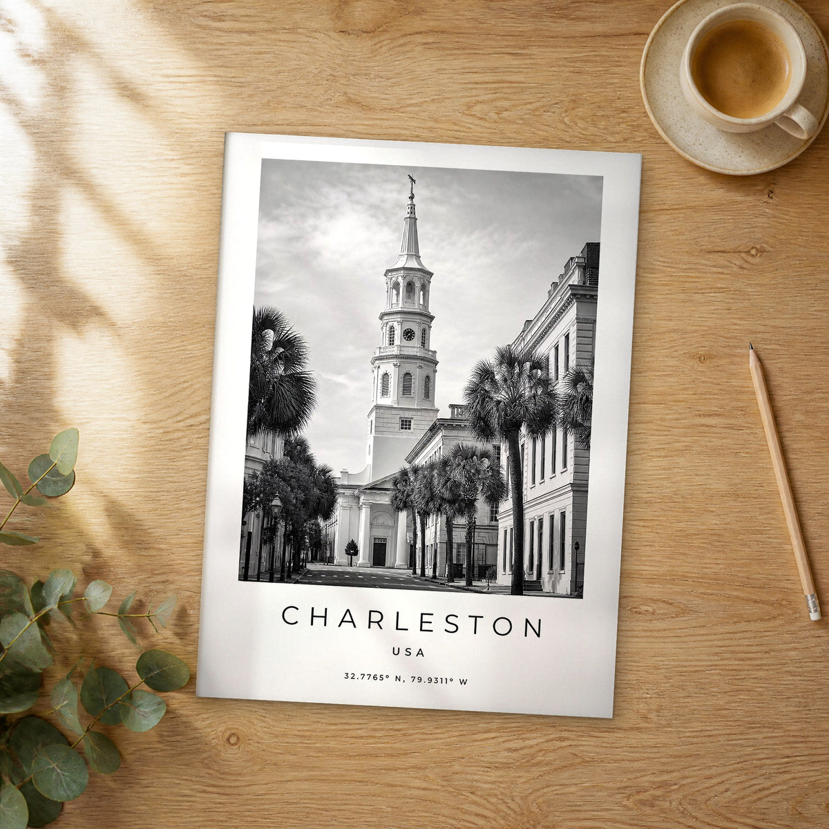 Unframed Charleston black and white travel poster on a wooden table
