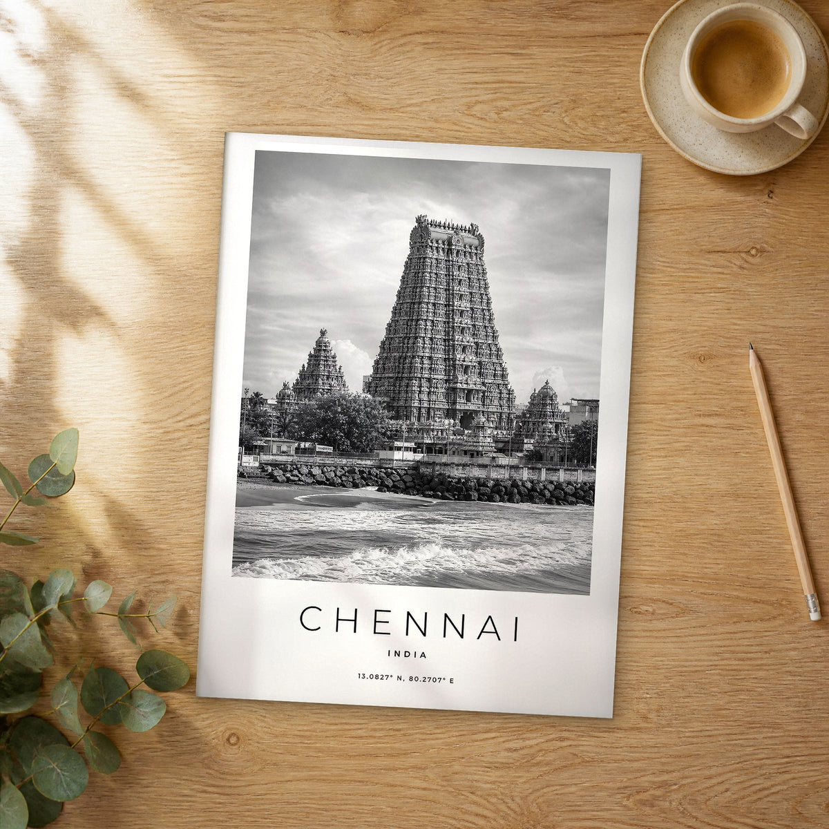Unframed Chennai black and white travel poster on a wooden table