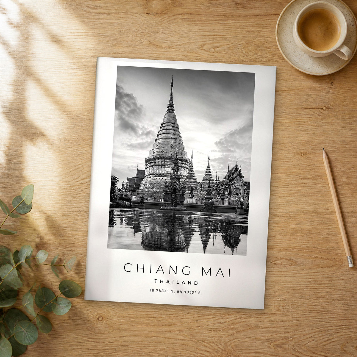 Unframed Chiang Mai black and white travel poster on a wooden table