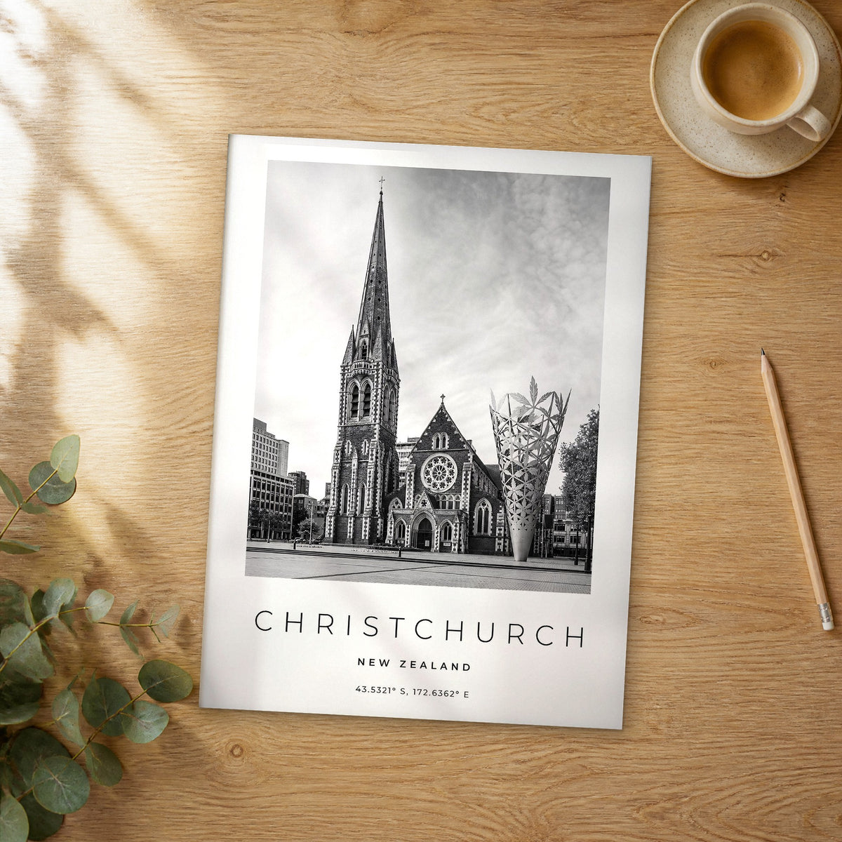 Unframed Christchurch black and white travel poster on a wooden table