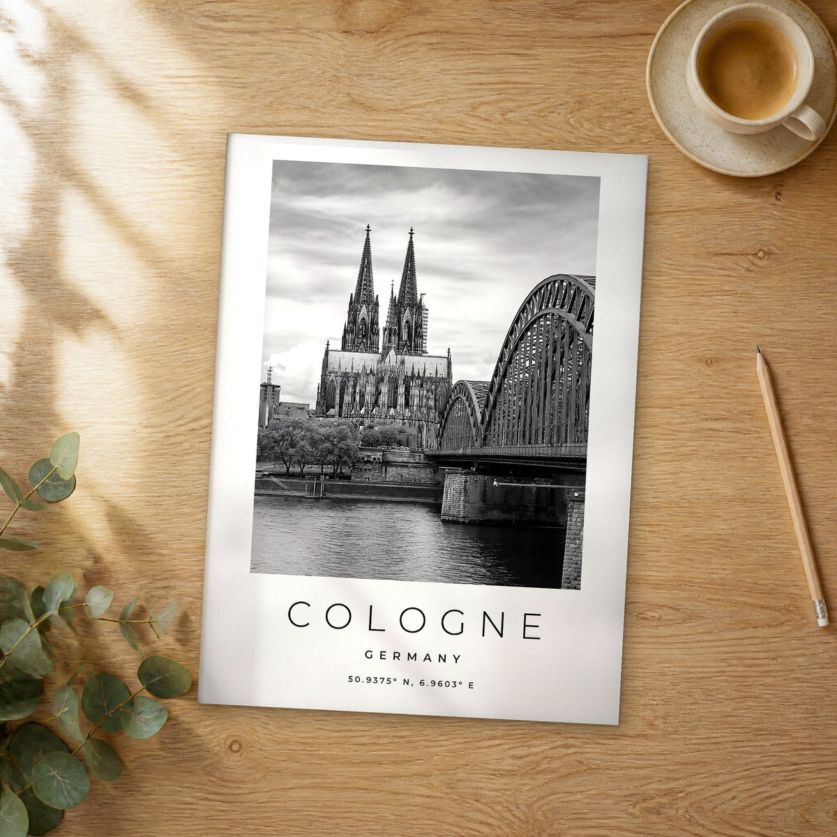 Unframed Cologne black and white travel poster on a wooden table