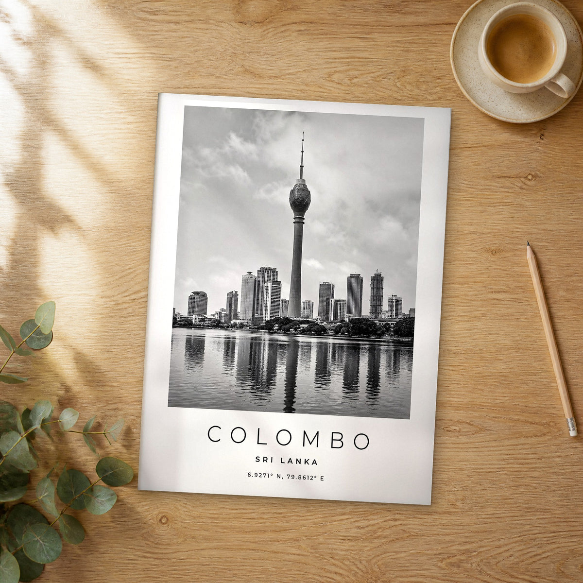 Unframed Colombo black and white travel poster on a wooden table