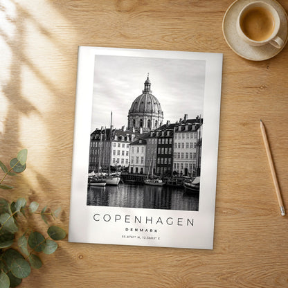 Unframed Copenhagen black and white travel poster on a wooden table