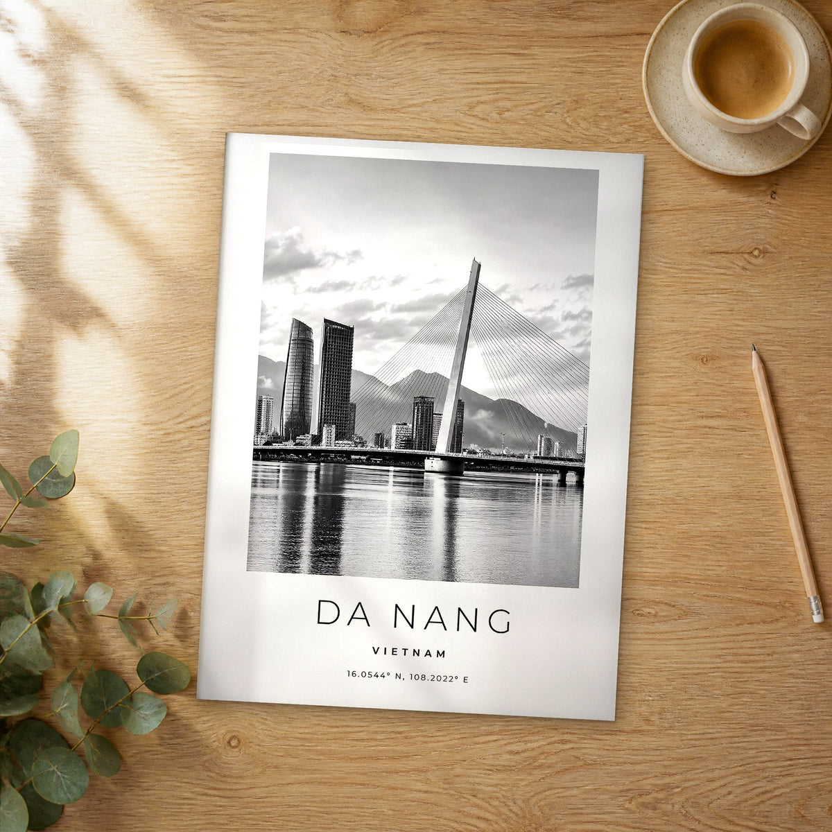 Unframed Da Nang black and white travel poster on a wooden table