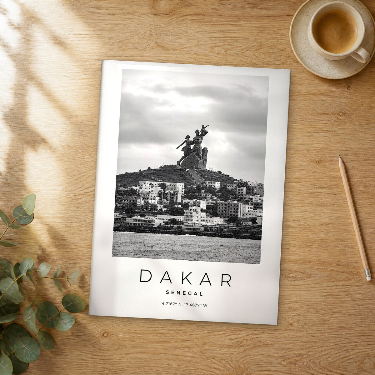 Unframed Dakar black and white travel poster on a wooden table
