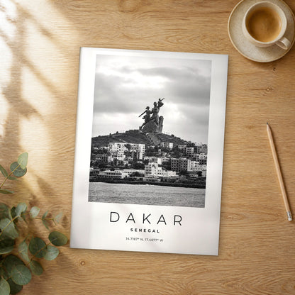 Unframed Dakar black and white travel poster on a wooden table