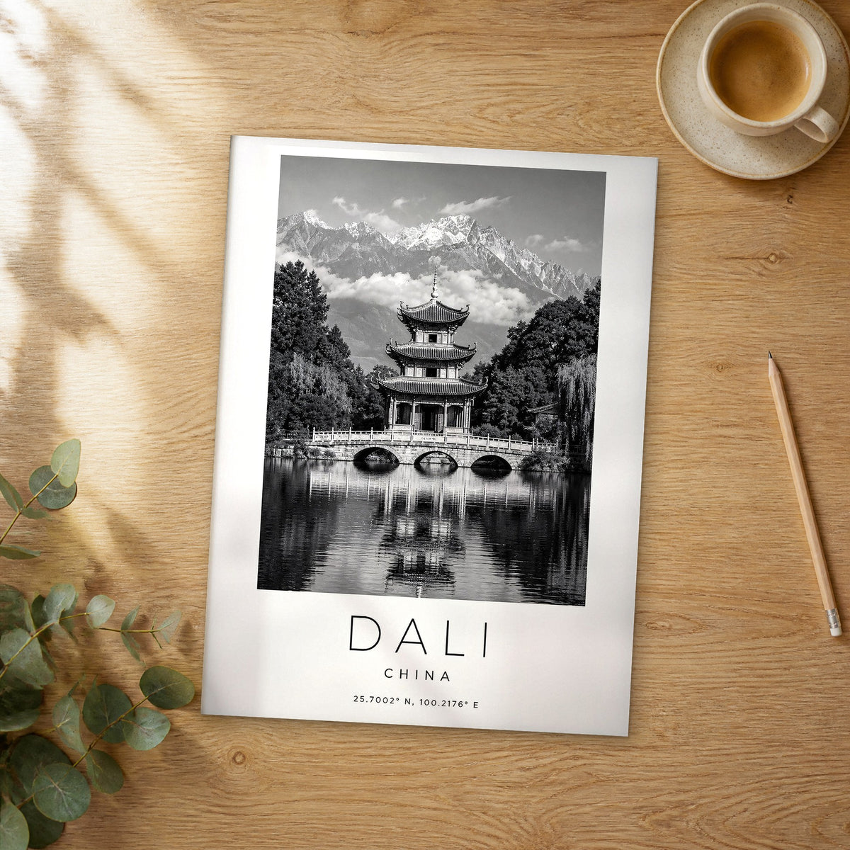 Unframed Dali Lakeside Pagoda Bridge black and white travel poster on a wooden table