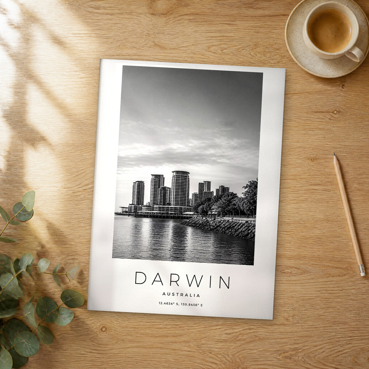 Unframed Darwin black and white travel poster on a wooden table