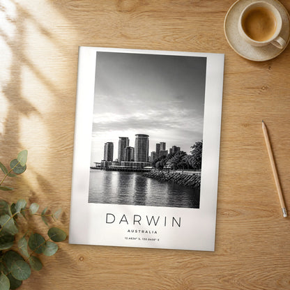 Unframed Darwin black and white travel poster on a wooden table