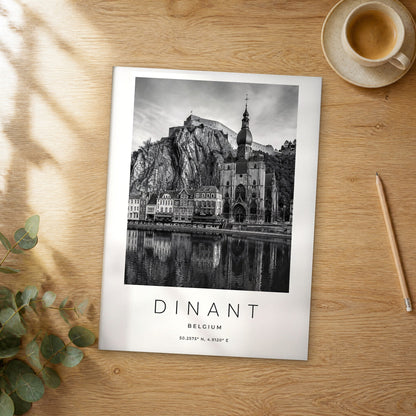 Unframed Dinant black and white travel poster on a wooden table