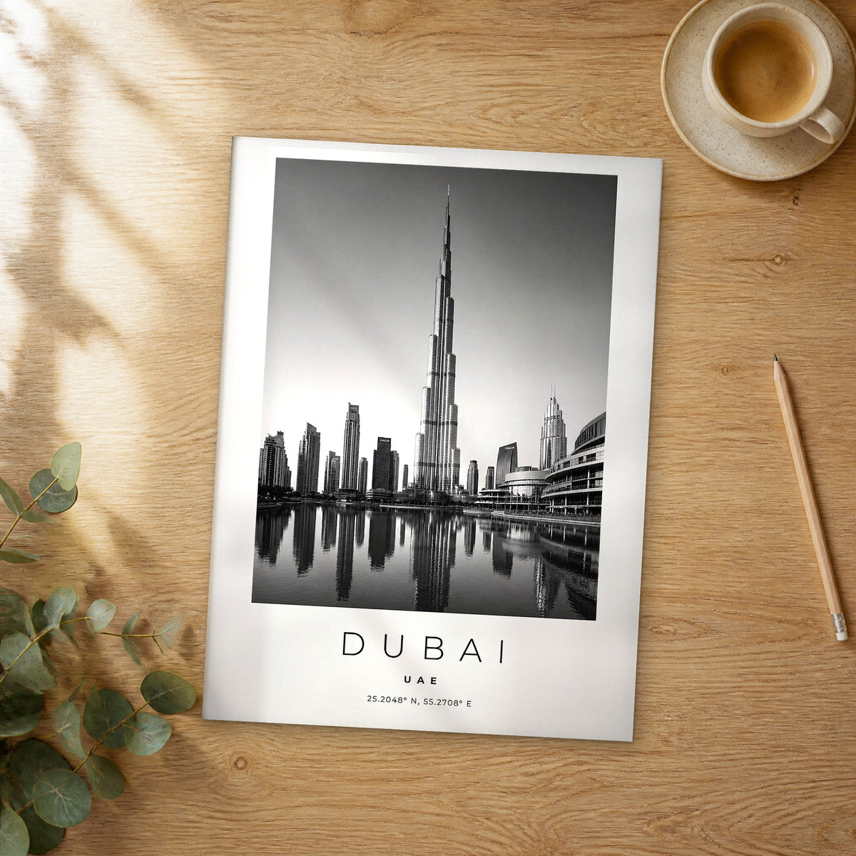 Unframed Dubai Burj Khalifa Reflection black and white travel poster on a wooden table