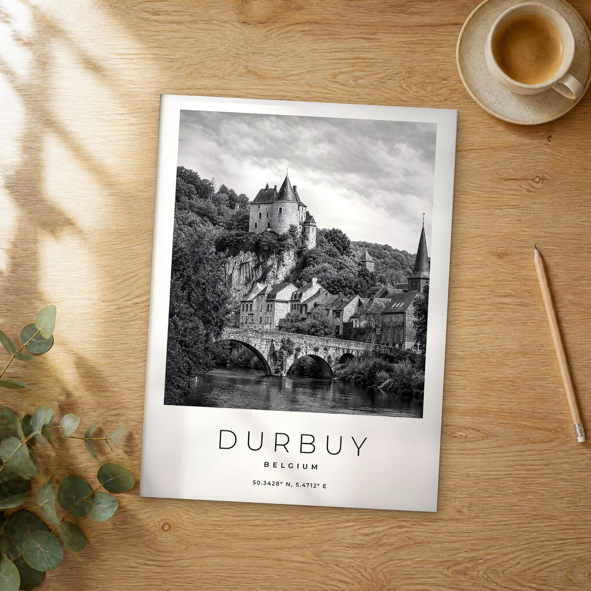 Unframed Durbuy black and white travel poster on a wooden table