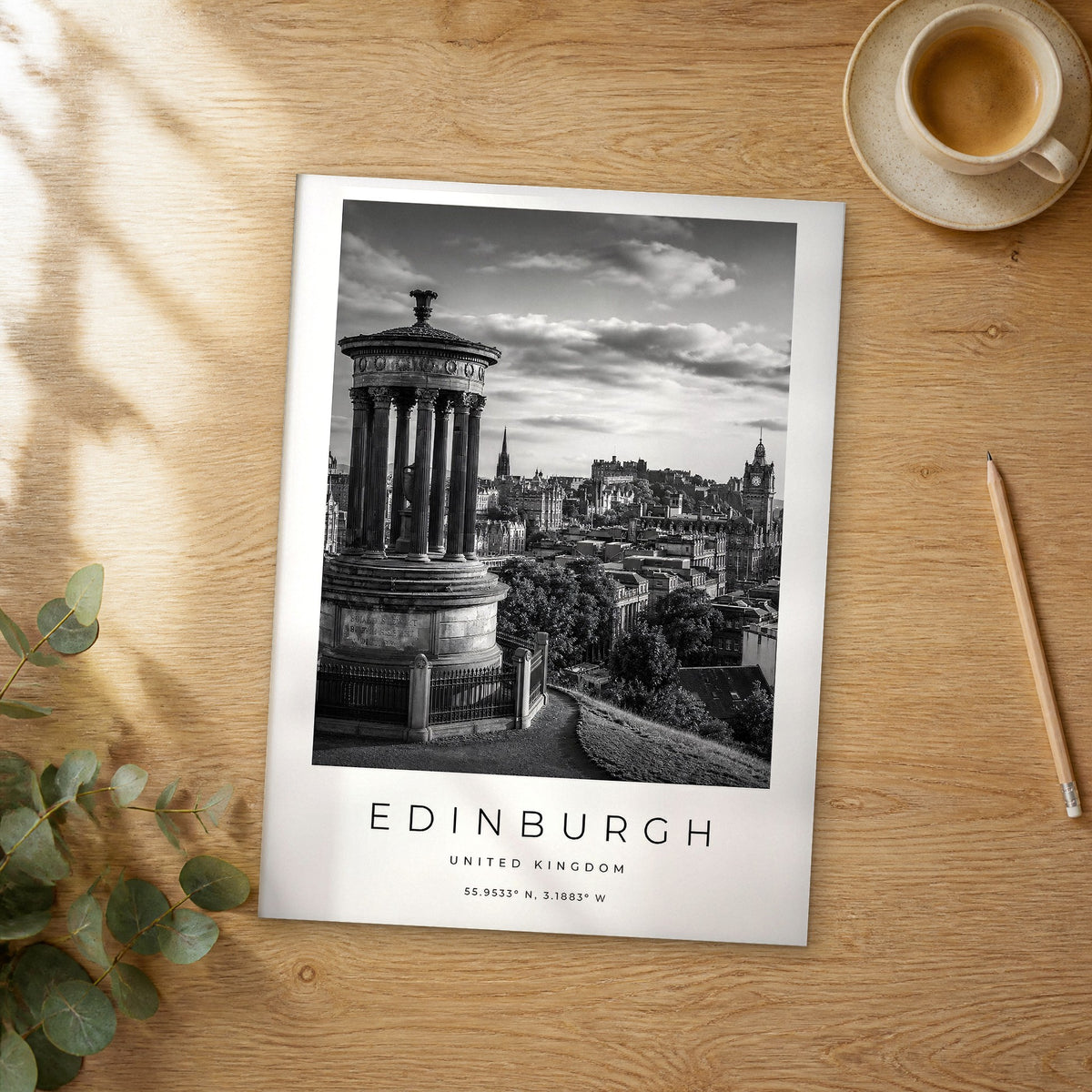 Unframed Edinburgh black and white travel poster on a wooden table