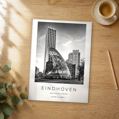 Unframed Eindhoven black and white travel poster on a wooden table