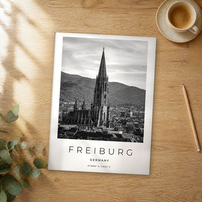 Unframed Freiburg black and white travel poster on a wooden table