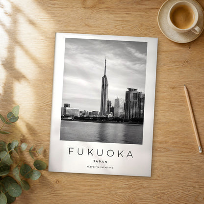 Unframed Fukuoka black and white travel poster on a wooden table