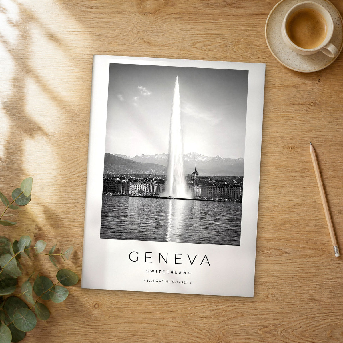 Unframed Geneva black and white travel poster on a wooden table