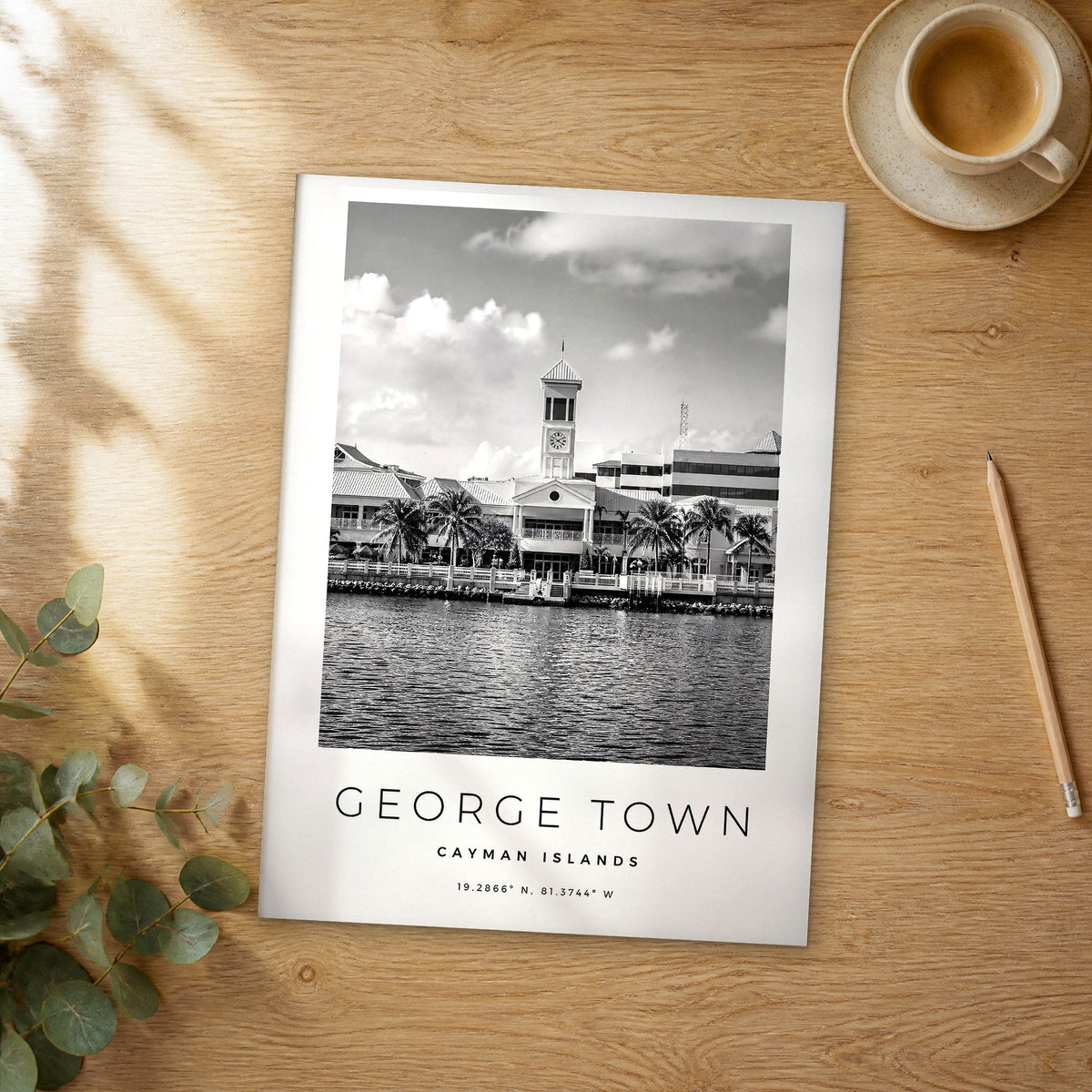 Unframed George Town black and white travel poster on a wooden table