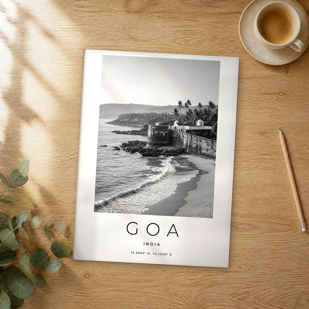 Unframed Goa black and white travel poster on a wooden table
