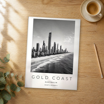 Unframed Gold Coast black and white travel poster on a wooden table
