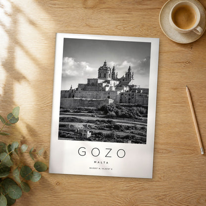 Unframed Gozo black and white travel poster on a wooden table
