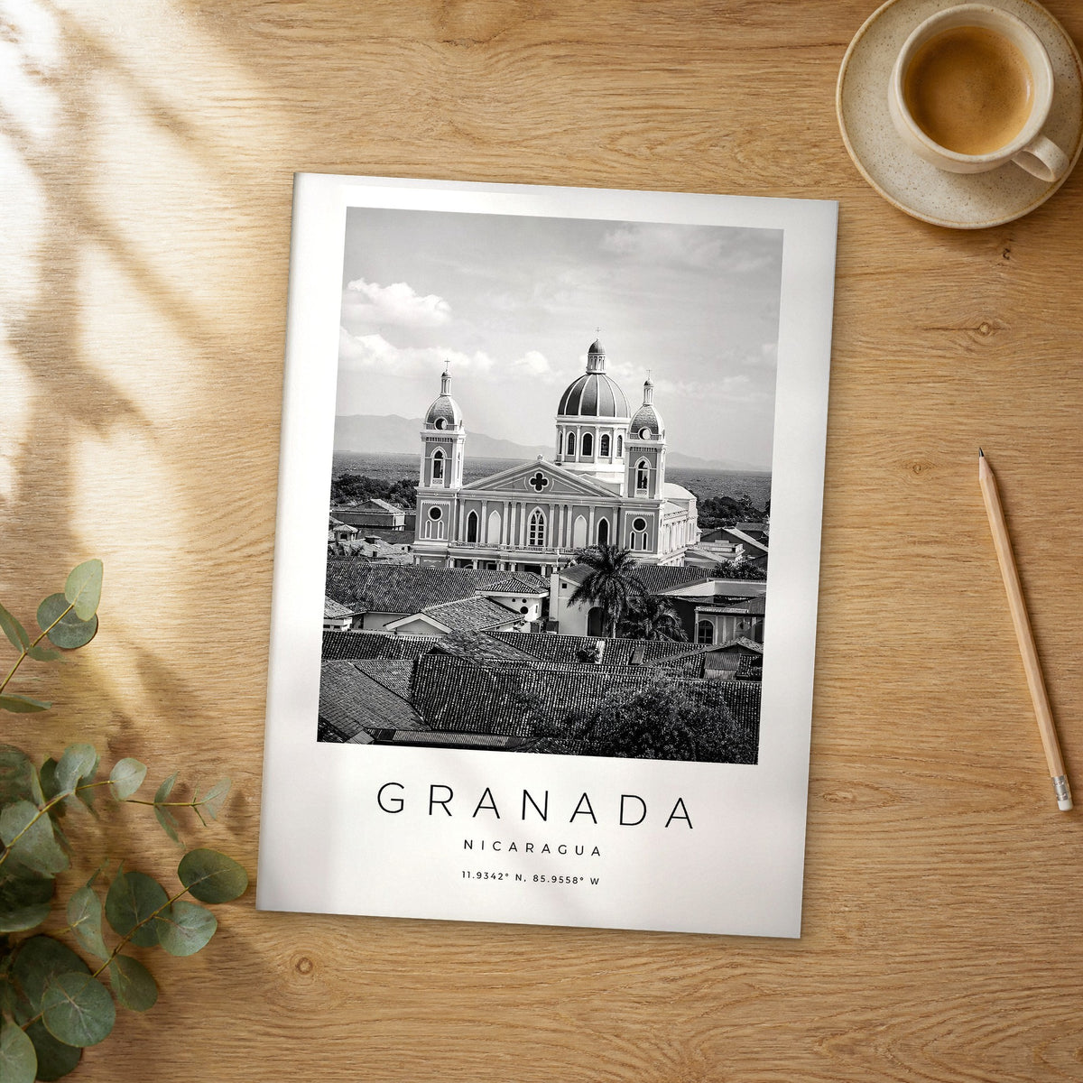 Unframed Granada black and white travel poster on a wooden table